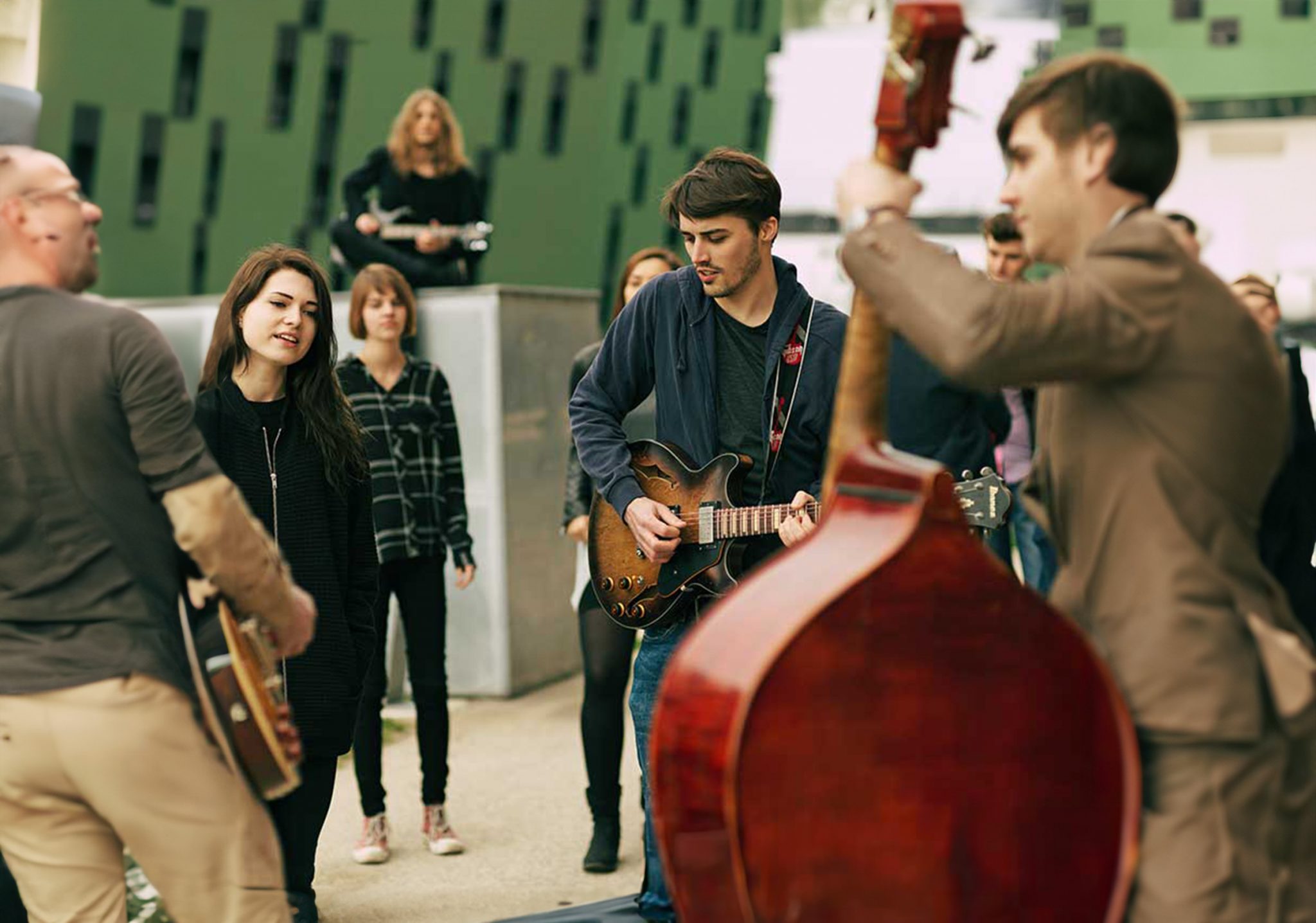 Studierende der Jam Music Lab University spielen ihre Instrumente bei einem Open-Air-Konzert